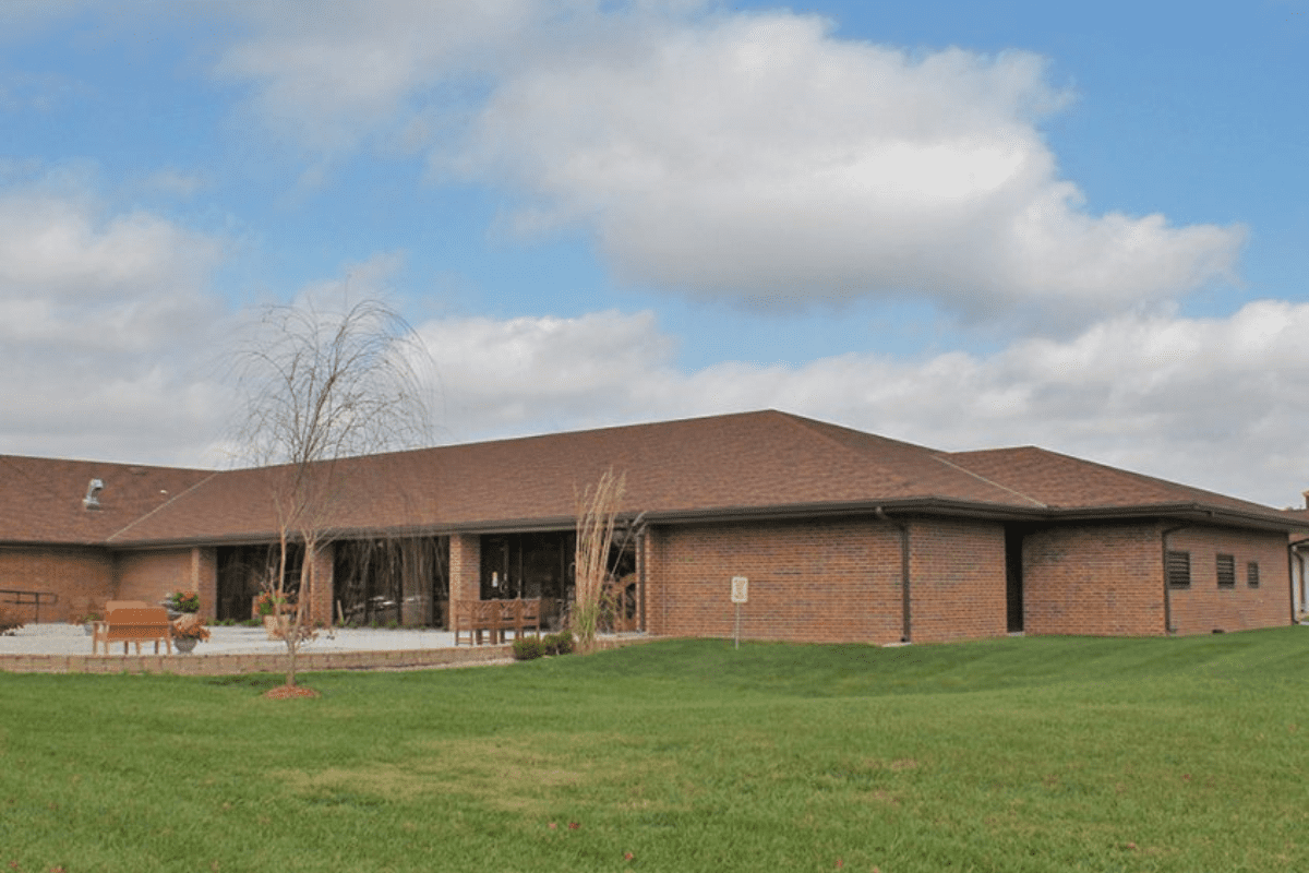 brick building with a large lawn